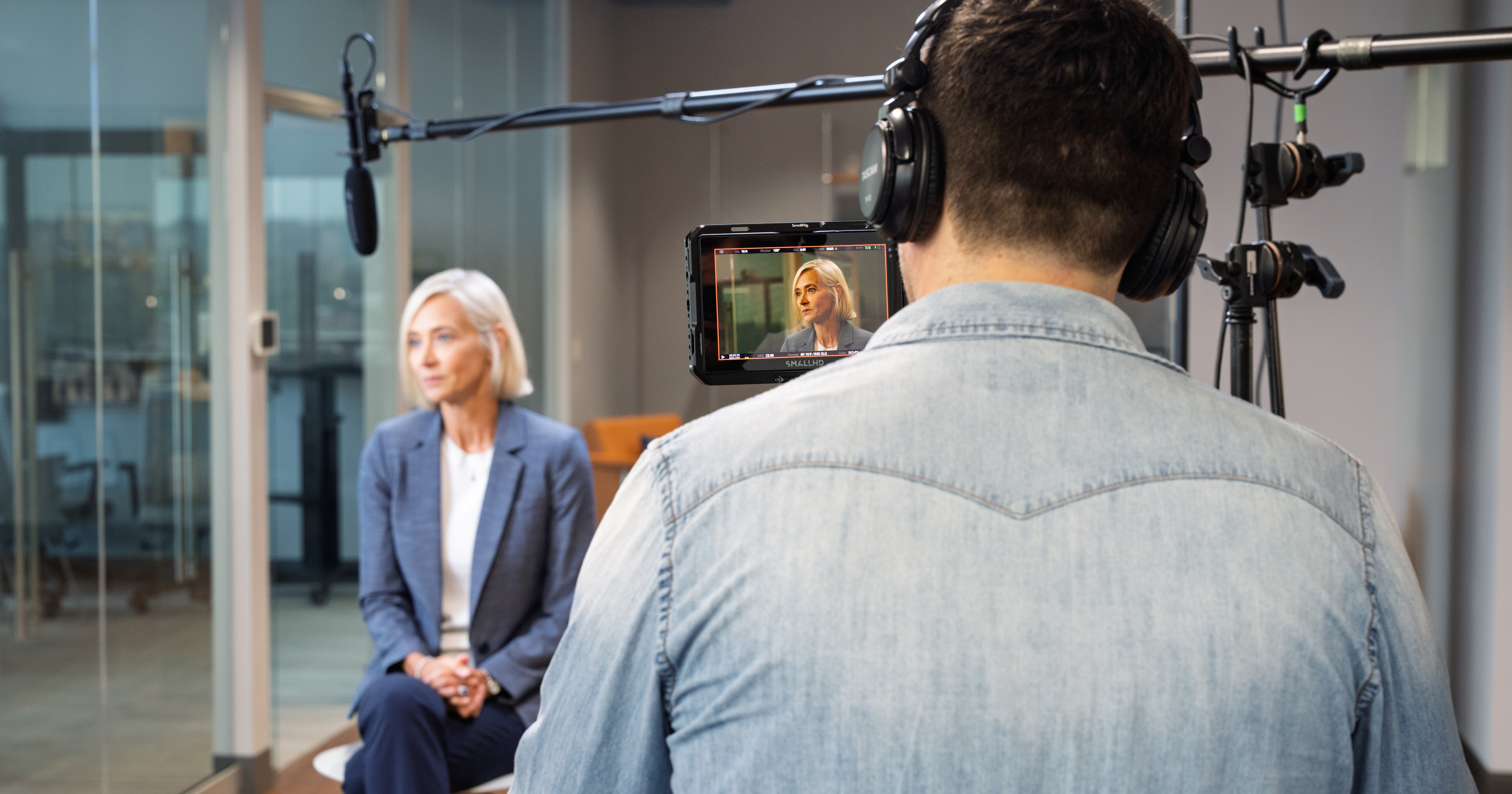 Behind-the-scenes photo of woman being interviewed on camera. 