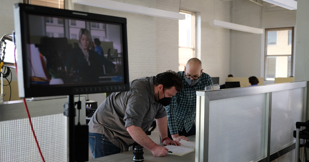 A director and producer review the script together on location.